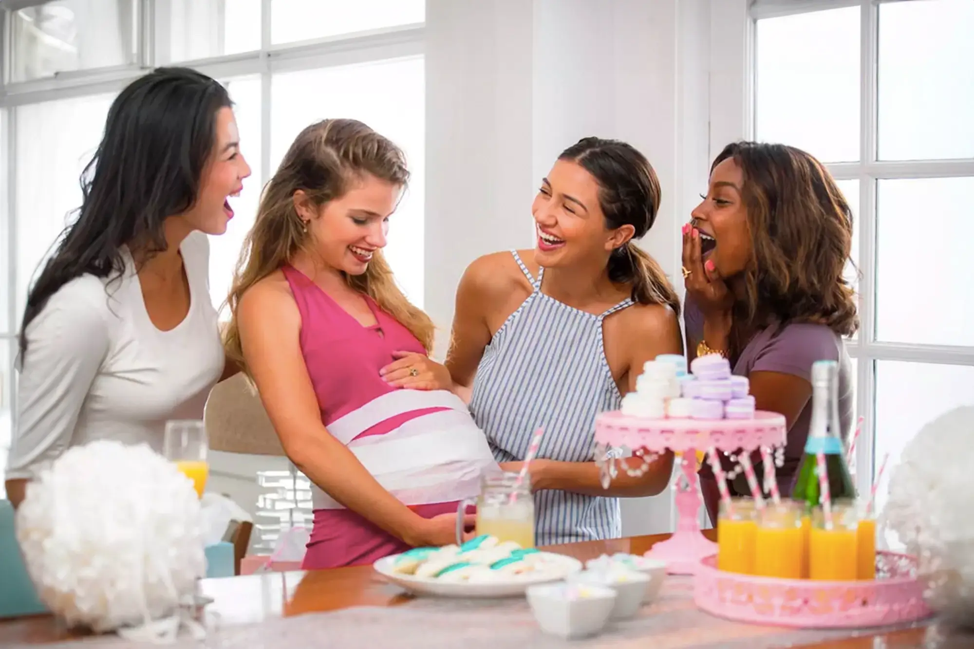 Quatro mulheres fazendo brincadeiras para Chá de Bebê